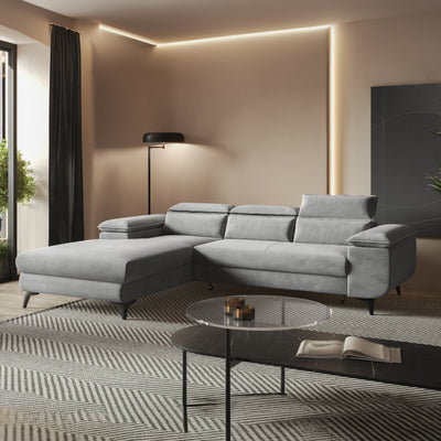 Ecksofa Bessi 276x205 Aschnebel (MONOLITH 84) im warm beleuchteten Wohnzimmer am Glastisch – Ecksofa fürs Wohnzimmer