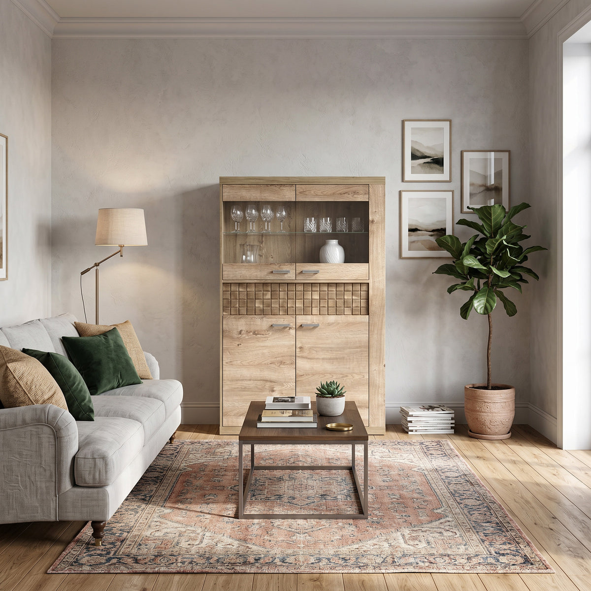 Vitrine Korin 102x160 im Wohnzimmer mit grauem Sofa und Orientteppich – Vitrine fürs Wohnzimmer mit Gläsern